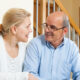 A woman and a man sitting on a couch to try the onboard process for Medicare Shepherd.