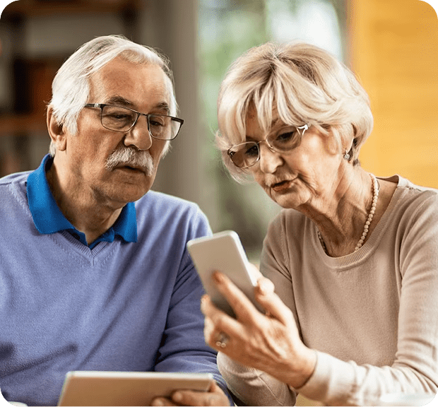 A woman and a man looking at a phone to learn more about Medicare plans